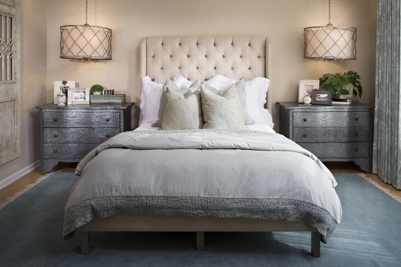 Chandeliers allow for extra space on the nightstands below them.