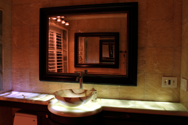 This uplight onyx counter makes for a dramatic powder room.